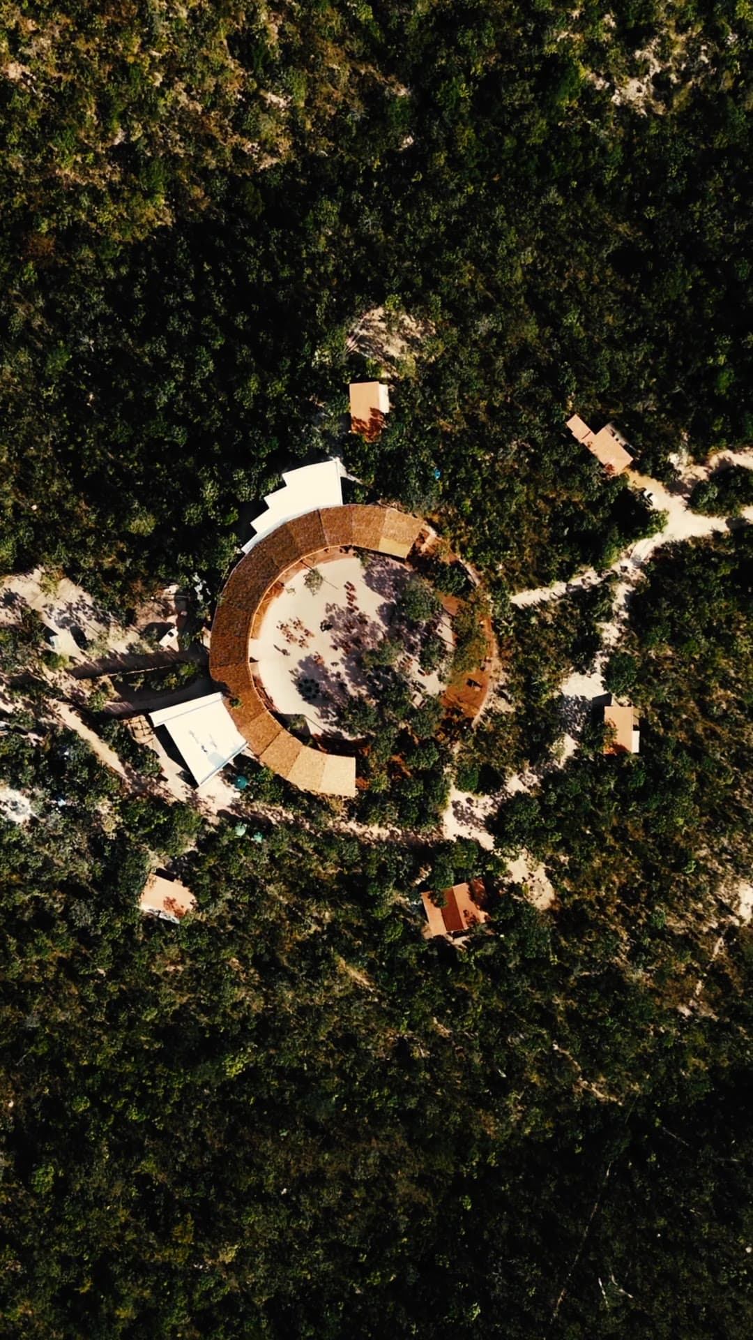 Mirante São Jorge — reel: the round building seen from straight above, a ring in the dark canopy.